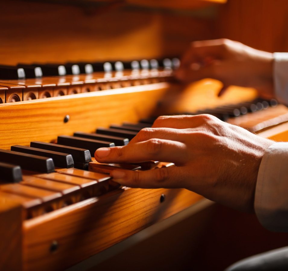 Detail of a man playing a church organ